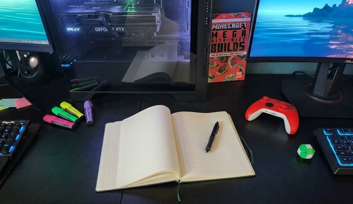Gaming desk setup with notebook, controller and Minecraft book at Good Game Counselling